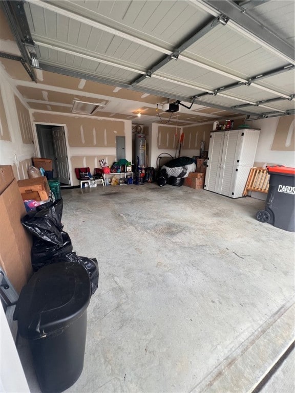 garage featuring electric panel, water heater, and a garage door opener