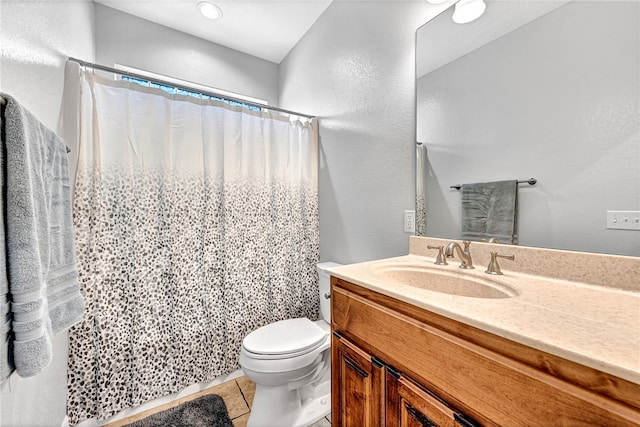 bathroom with tile patterned floors, vanity, and toilet