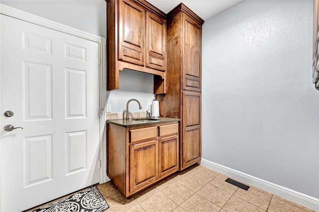 kitchen with sink and light tile patterned floors