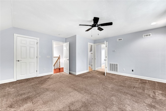 unfurnished bedroom featuring carpet, vaulted ceiling, and ceiling fan