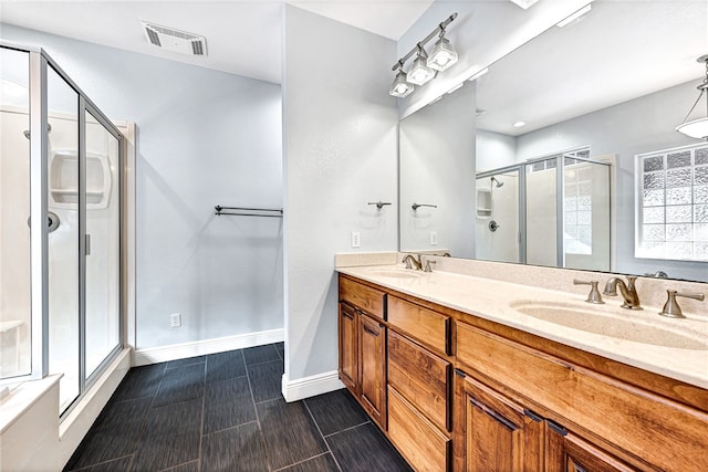 bathroom with vanity and a shower with door