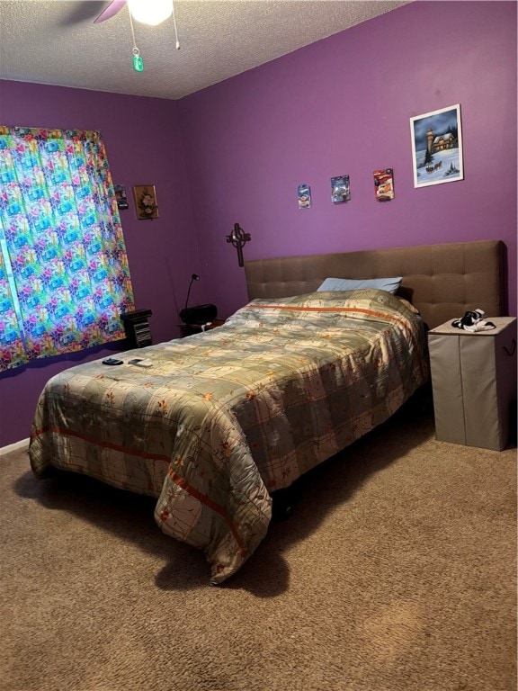 carpeted bedroom with a textured ceiling and ceiling fan