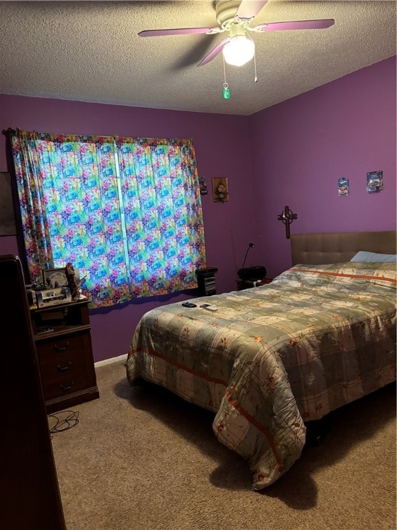 carpeted bedroom featuring a textured ceiling and ceiling fan