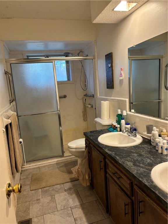 bathroom with walk in shower, a textured ceiling, backsplash, vanity, and toilet