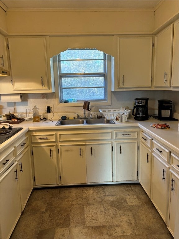 kitchen with black cooktop and sink