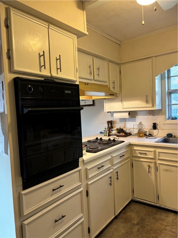 kitchen with cooktop, sink, tasteful backsplash, black oven, and crown molding