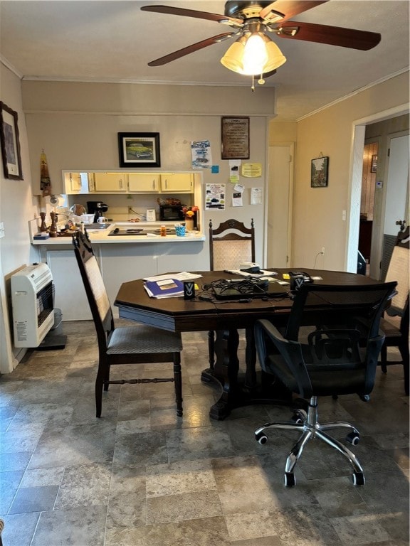 dining space featuring ceiling fan, crown molding, and heating unit