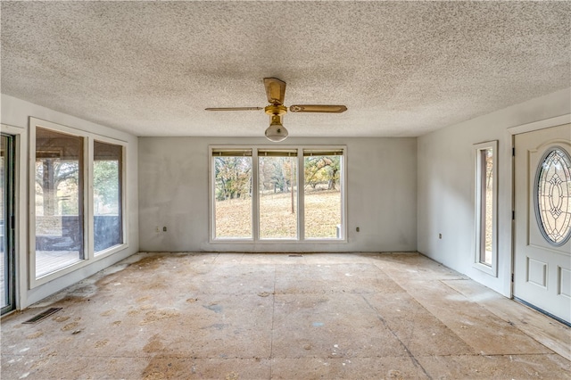 entryway with a textured ceiling and ceiling fan