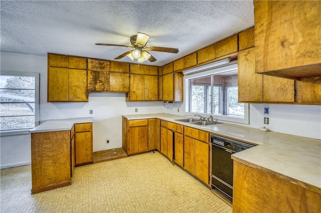 kitchen featuring a textured ceiling, ceiling fan, black dishwasher, and sink