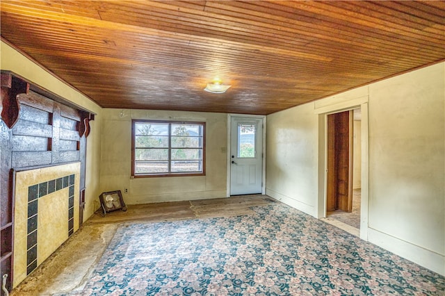 unfurnished living room with a tile fireplace and wood ceiling