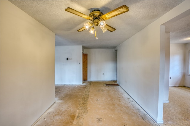 spare room featuring ceiling fan and a textured ceiling