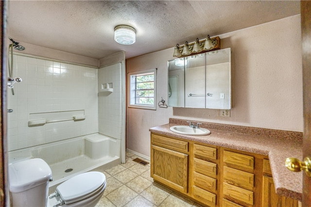 bathroom featuring walk in shower, vanity, toilet, and a textured ceiling