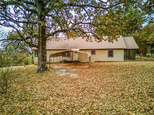 exterior space with a sunroom and a carport