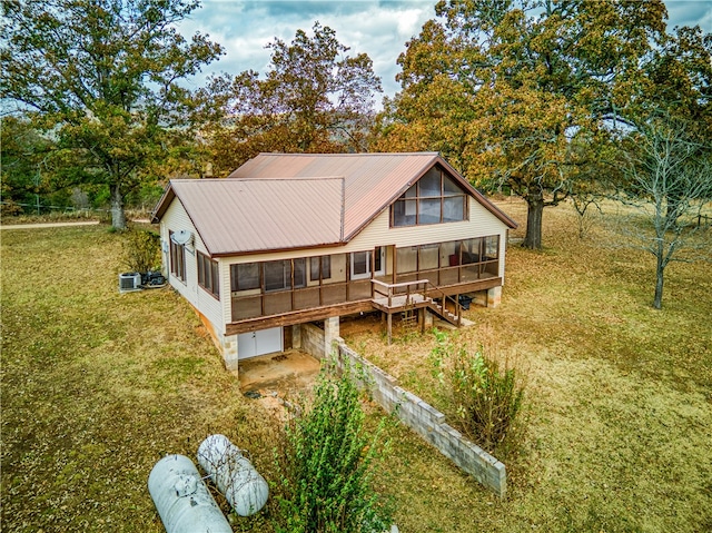 back of house with a sunroom and a yard