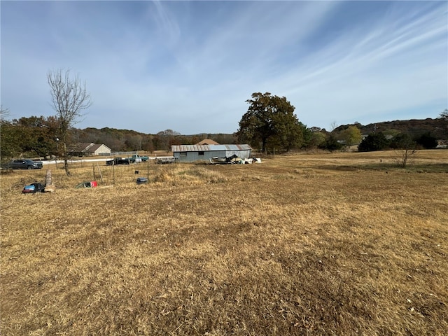 view of yard with a rural view