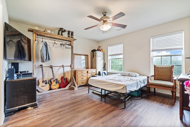 bedroom with hardwood / wood-style flooring and ceiling fan