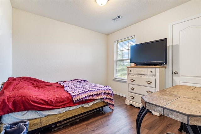 bedroom featuring dark hardwood / wood-style flooring