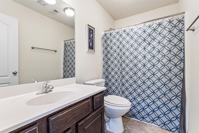 bathroom with toilet, vanity, a shower with shower curtain, and tile patterned flooring