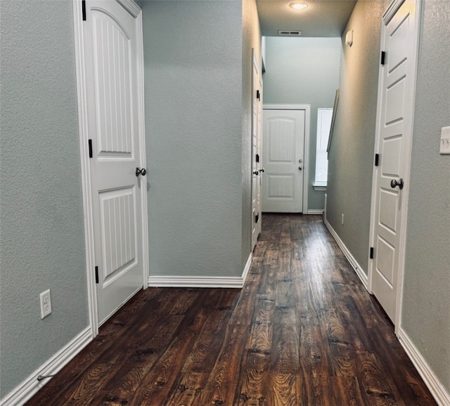 hall with dark hardwood / wood-style flooring