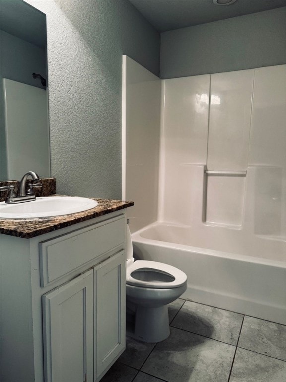 full bathroom featuring vanity, tile patterned floors, bathing tub / shower combination, and toilet