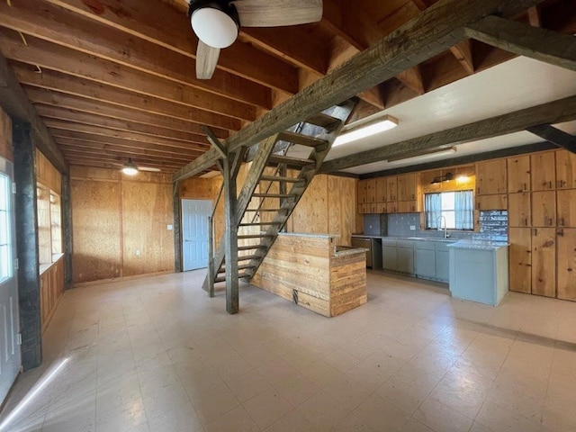 kitchen with wood walls, a wealth of natural light, and tasteful backsplash