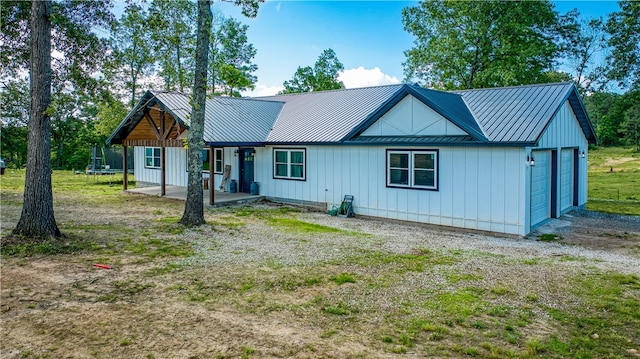 view of front of home with a garage and a trampoline