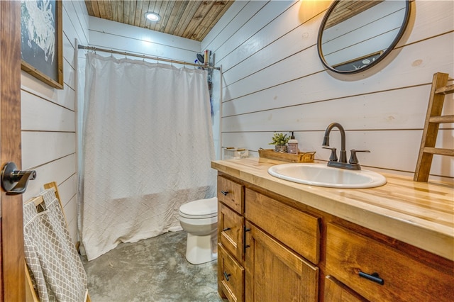 bathroom featuring toilet, wood ceiling, wood walls, concrete flooring, and vanity