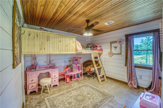 bedroom with wooden walls, wooden ceiling, and ceiling fan