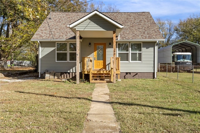 bungalow-style house with a carport and a front lawn