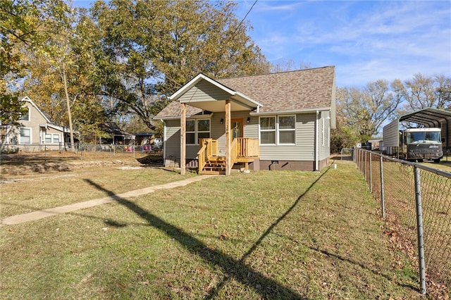 view of front of home featuring fence, crawl space, roof with shingles, a carport, and a front lawn