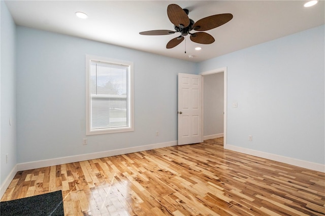 empty room with a ceiling fan, recessed lighting, baseboards, and light wood finished floors