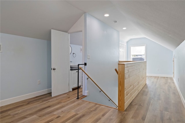 bonus room featuring light wood-style flooring, baseboards, vaulted ceiling, and recessed lighting