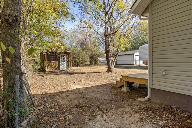 view of yard featuring a storage shed and an outbuilding