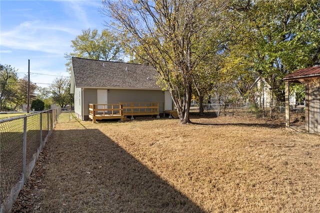 view of yard with a deck and a fenced backyard