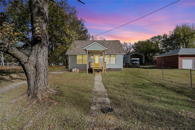 bungalow featuring a detached carport, crawl space, fence, and a front yard