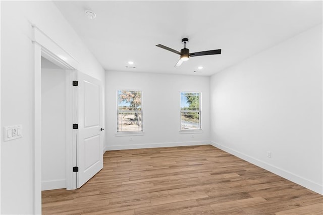 spare room with a ceiling fan, light wood finished floors, recessed lighting, and baseboards