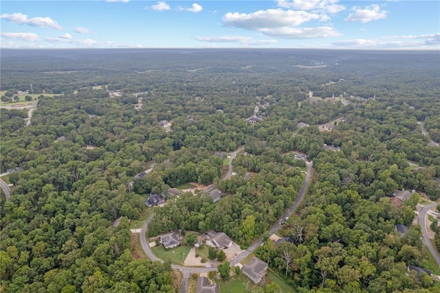 drone / aerial view featuring a wooded view