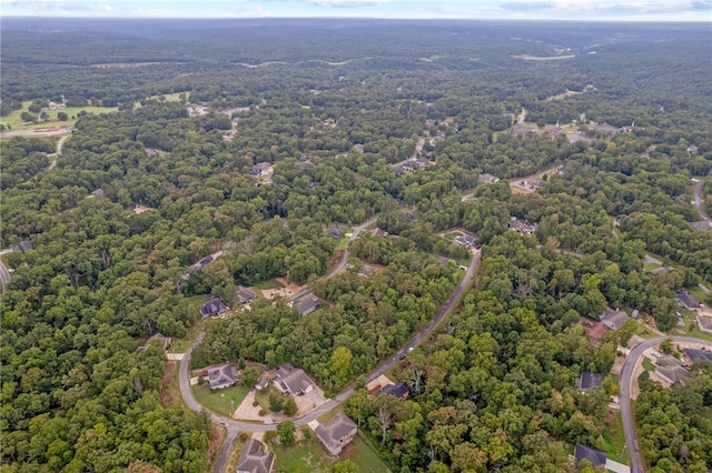 birds eye view of property featuring a forest view