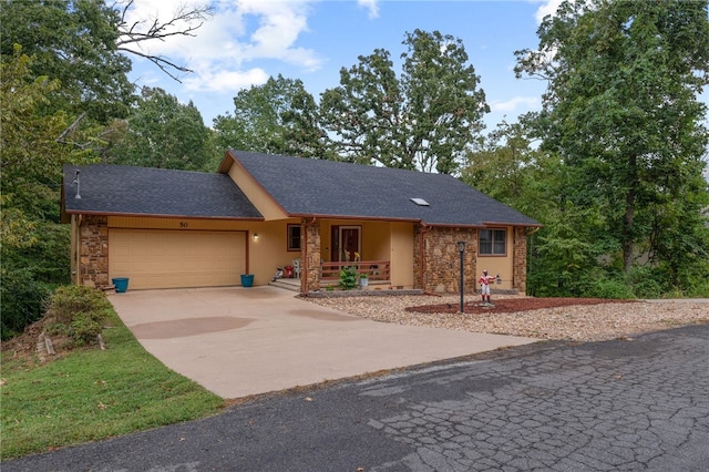 ranch-style house with covered porch and a garage