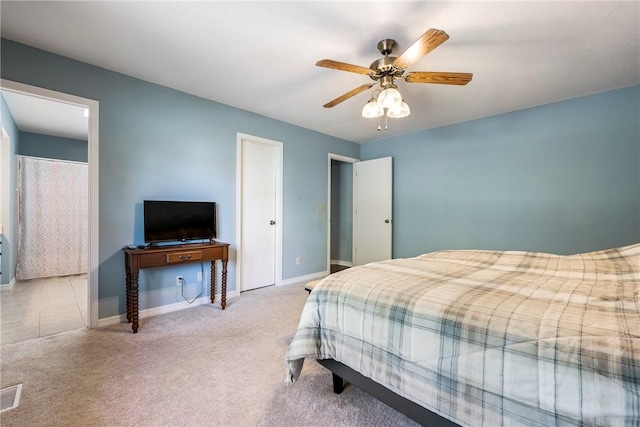 bedroom with visible vents, baseboards, carpet, and a ceiling fan