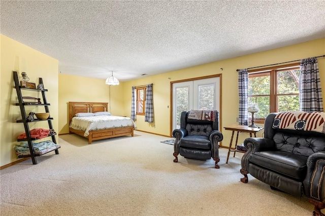 bedroom with a textured ceiling, baseboards, carpet, and access to outside