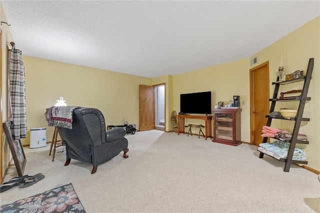 living room featuring a textured ceiling, visible vents, and light carpet