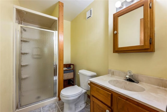 bathroom with visible vents, toilet, a stall shower, and vanity