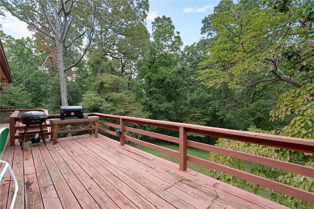 wooden terrace featuring a grill