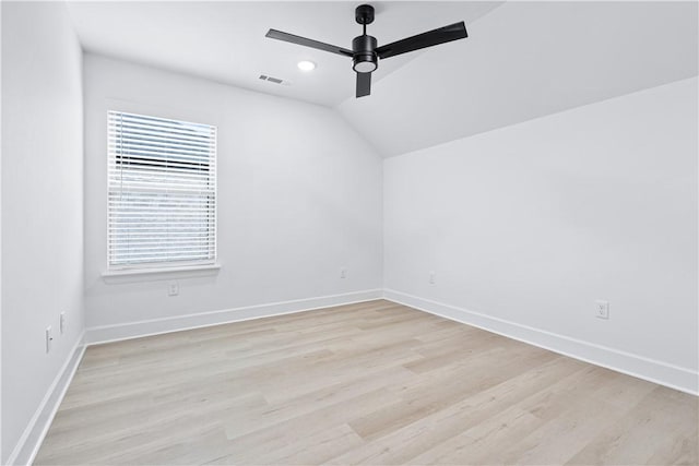 unfurnished room with lofted ceiling, ceiling fan, and light hardwood / wood-style floors