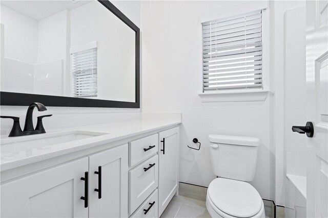 full bathroom with toilet, vanity, tile patterned floors, and bathing tub / shower combination