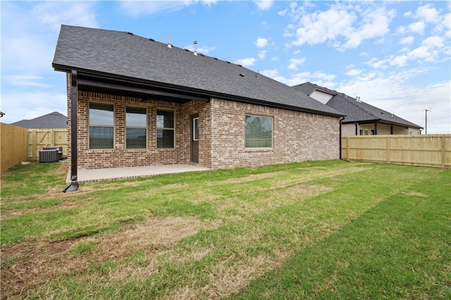 rear view of house featuring a patio, cooling unit, and a lawn