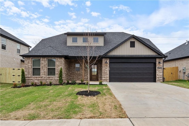 view of front of house featuring a front lawn and a garage