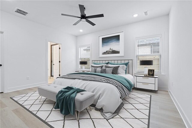 bedroom with ceiling fan and light wood-type flooring