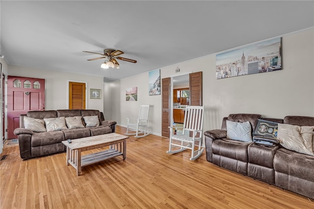 living room featuring ceiling fan and light hardwood / wood-style flooring